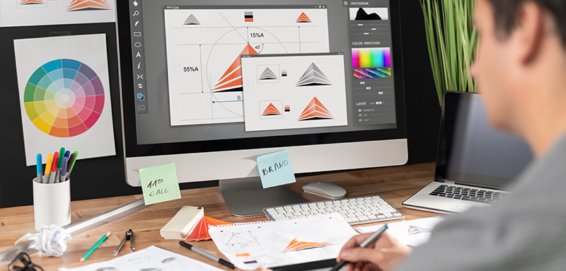 Male graphic designer working with tablet in office