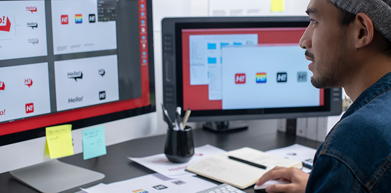 Male graphic designer working with tablet in office