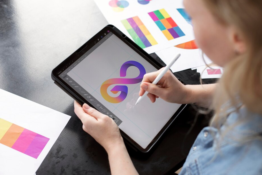 Young female logo designer working on a graphic tablet